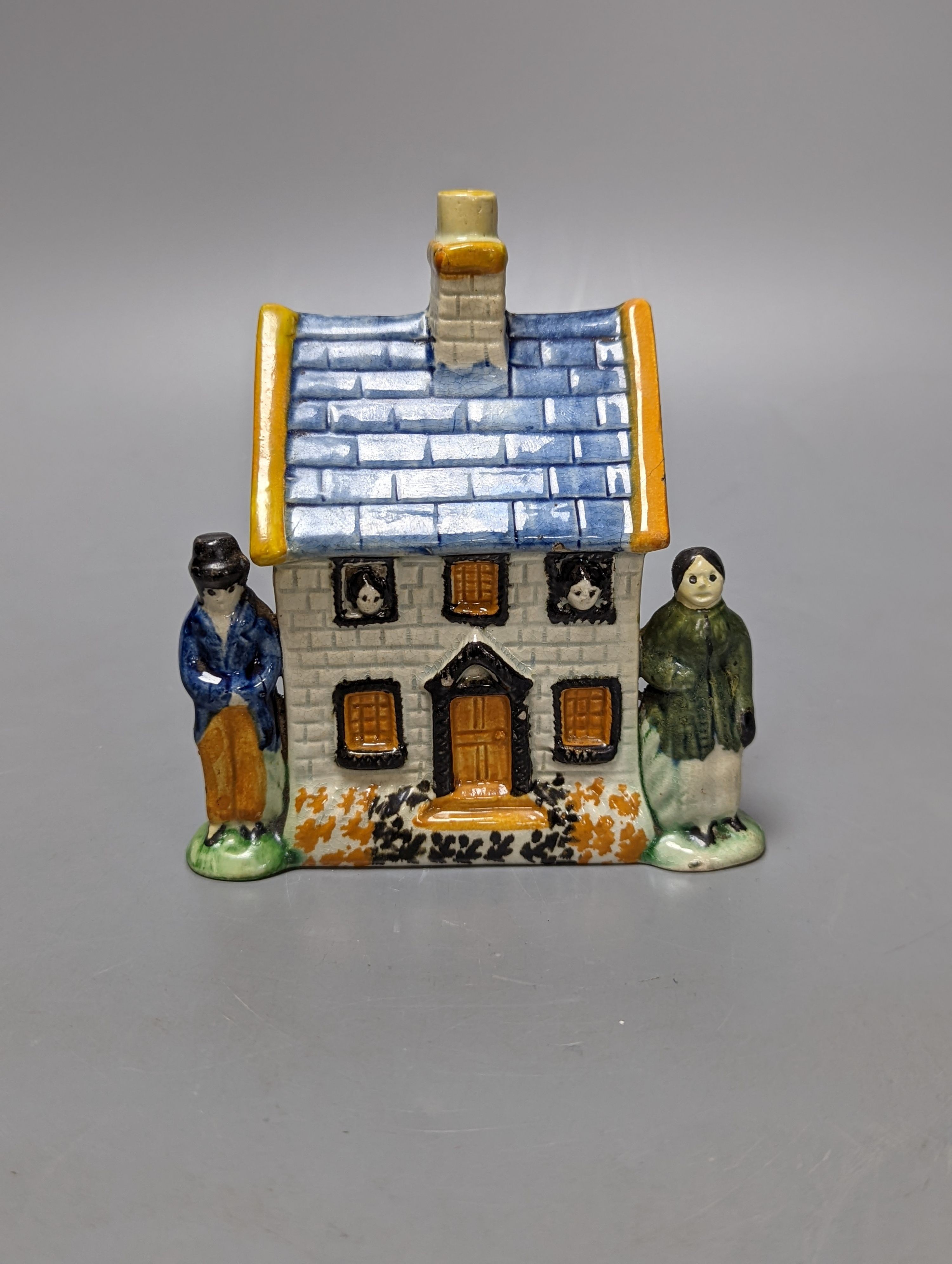 A Staffordshire Prattware money box, c.1810, and another later example (2) both 12.5cm, faults